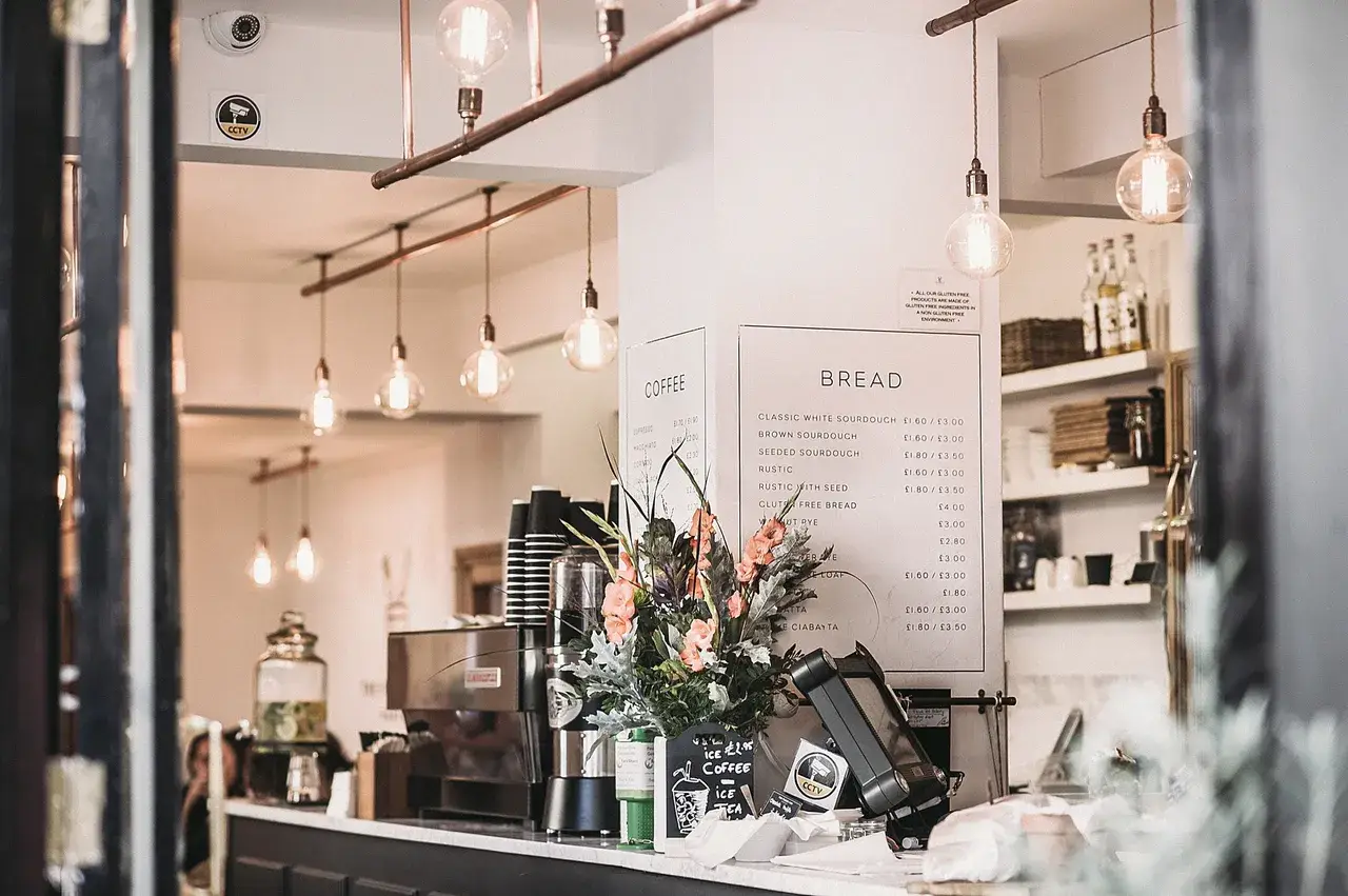 A restaurant with lights hanging above the counter.